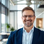 Fangen Sie das Interesse mit einem Business Portrait München eines lächelnden Geschäftsführers ein.